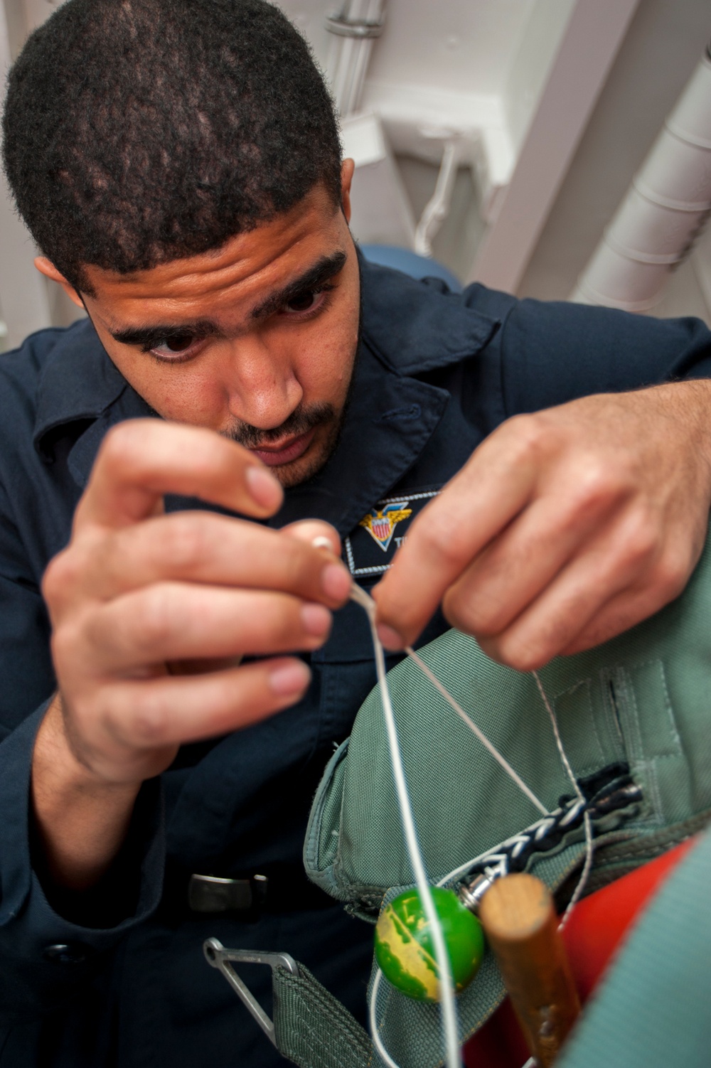 USS Carl Vinson Sailors conduct parachute maintenance