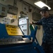 USS John C. Stennis Sailors work with sheet metal