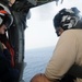 Helicopter Sea Combat Squadron 6 Seahawk aircrewman shows shows midshipman how to use the rappel cable