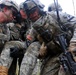 Soldiers carry simulated casualty to medics during Combined Resolve III