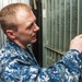 USS George Washington Sailor stocks a vending machine