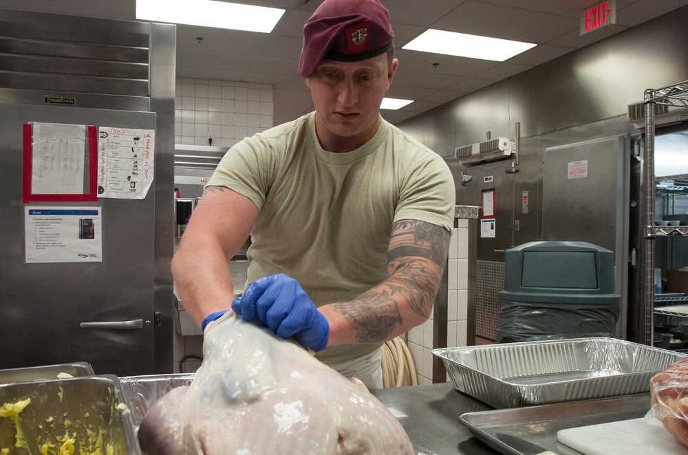 7th Special Forces Group (Airborne) Soldiers prepare Thanksgiving meal