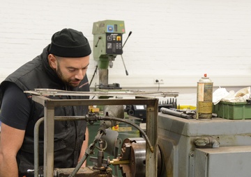 Belgian civilian workers fix and maintain Army properties.