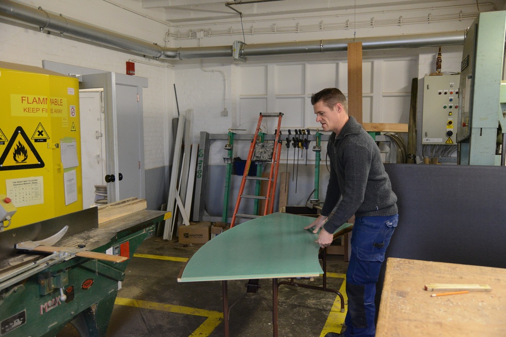 Belgian civilian workers fix and maintain Army properties.