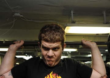 USS Nimitz Sailor works out