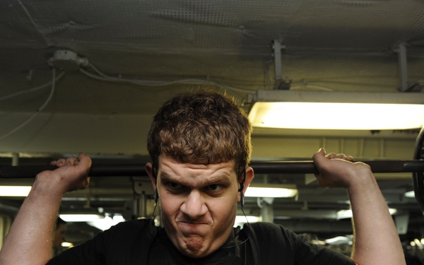 USS Nimitz Sailor works out