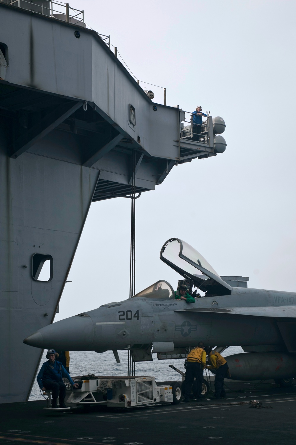 USS Nimitz Sailors chain down an F/A-18E Super Hornet