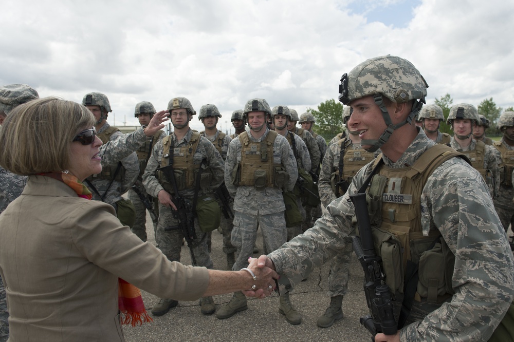 Deanie Dempsey shakes hands with an Airman