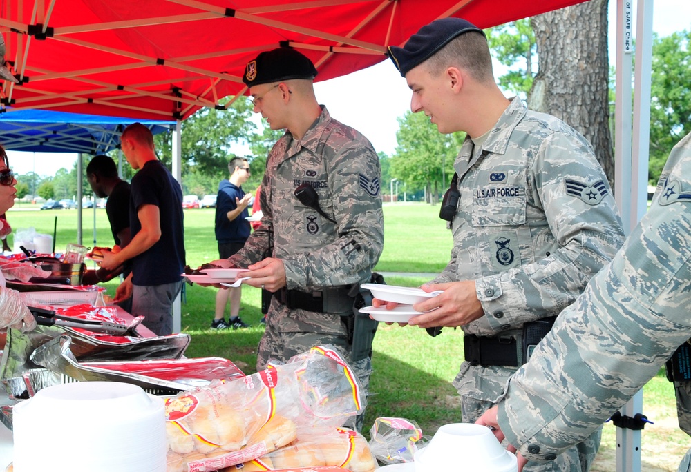 Airmen get their fill of warm weather, comfort food during BBQ