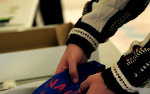 Volunteers package patron's presents