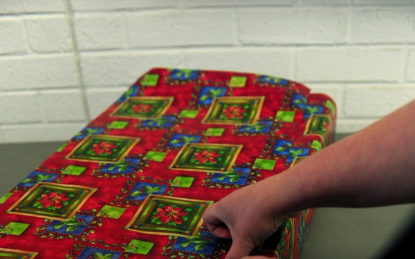 Volunteers package patron's presents