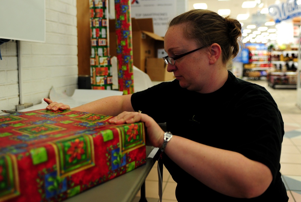 Volunteers package patron's presents