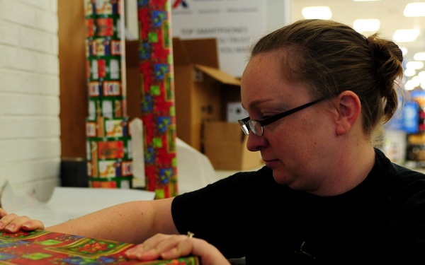 Volunteers package patron's presents