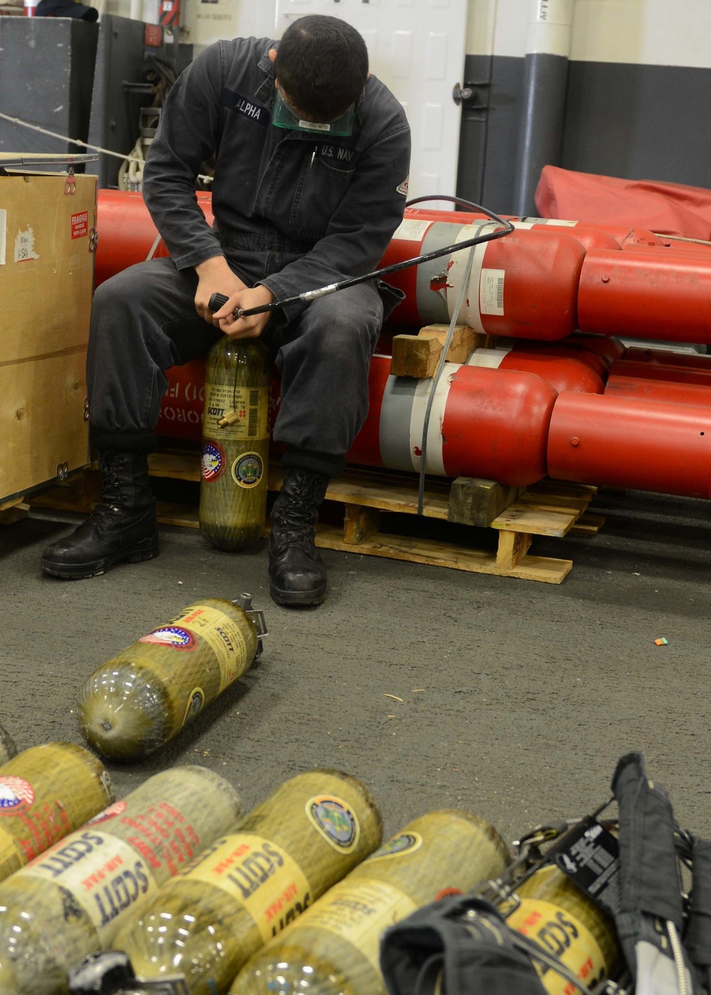 USS Bonhomme Richard Sailor refills a self-contained breathing apparatus