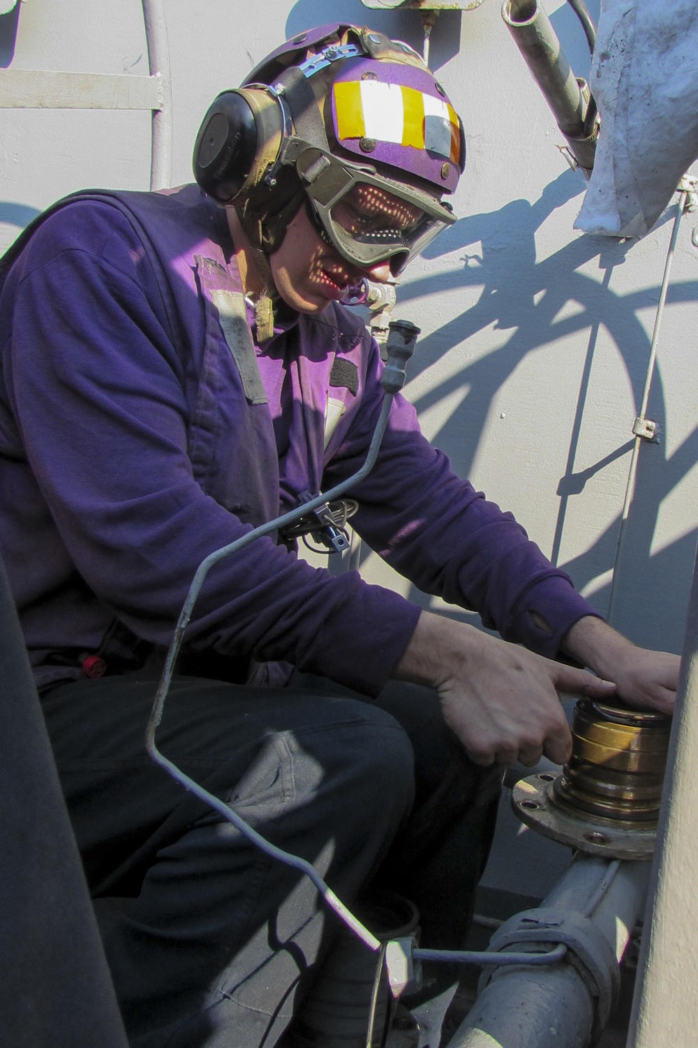 USS Carl Vinson Sailors repair a fueling station swing joint