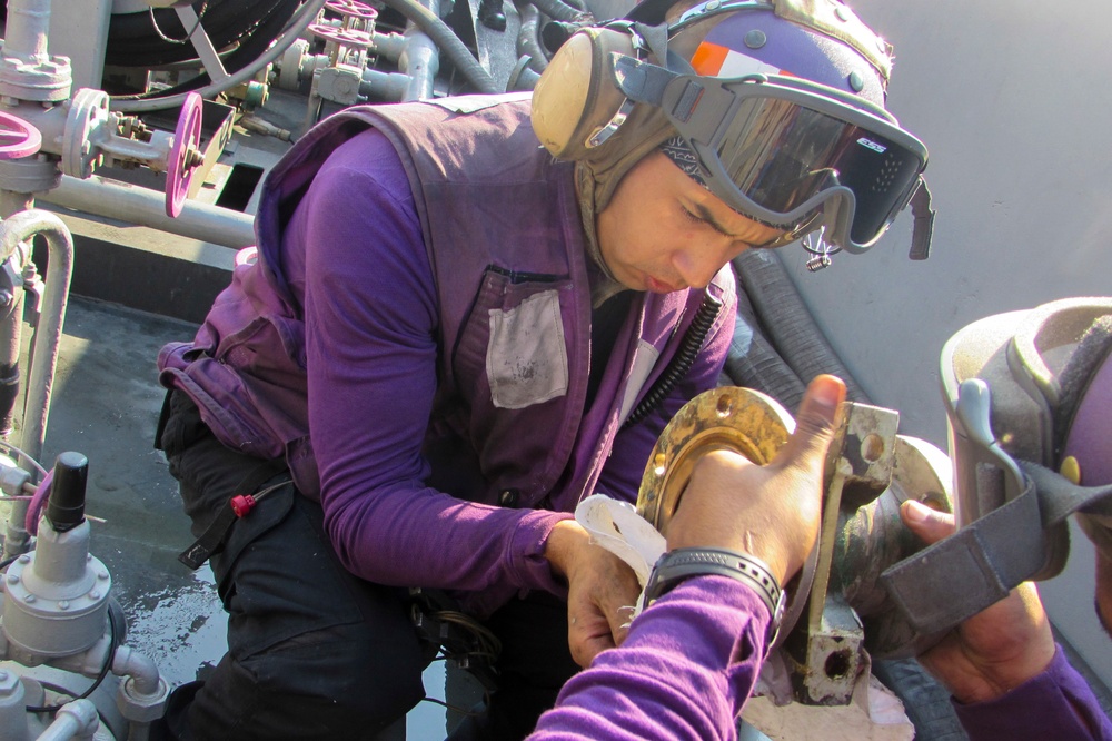 USS Carl Vinson Sailors repair a fueling station swing joint