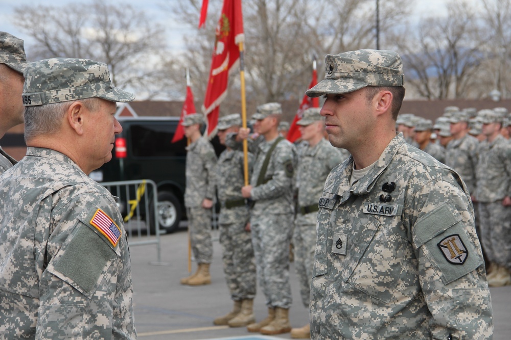 Gen. Grass presents Soldiers Medal to Staff Sgt. Robert Kelley for heroism at Camp Williams Dec. 6, 2014