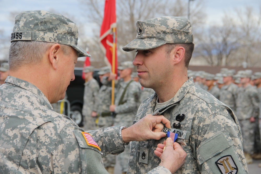 Gen. Grass presents Soldiers Medal to Staff Sgt. Robert Kelley for heroism at Camp Williams Dec. 6, 2014