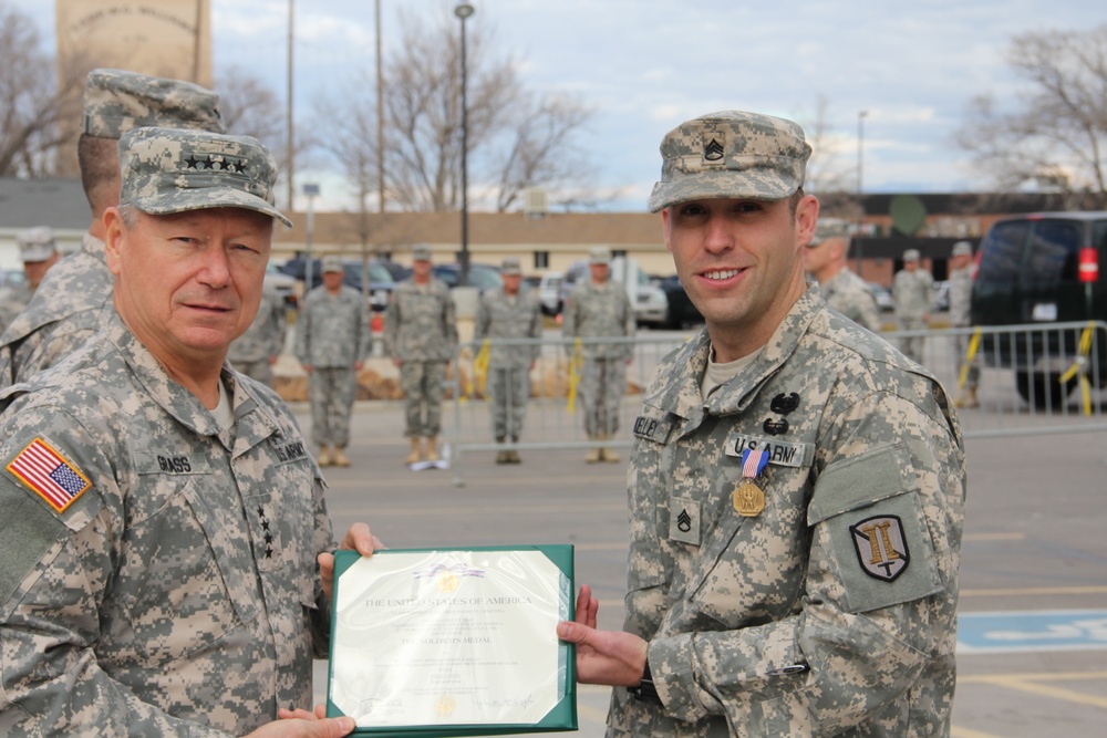 Gen. Grass presents Soldiers Medal to Staff Sgt. Robert Kelley for heroism at Camp Williams Dec. 6, 2014