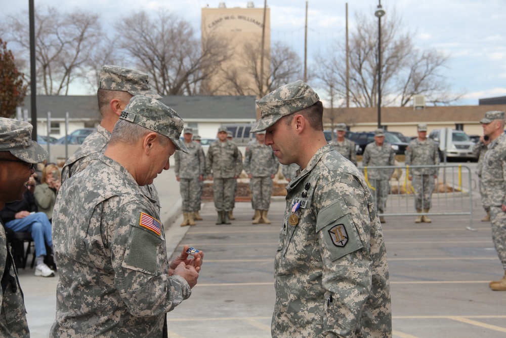 Gen. Grass presents Soldiers Medal to Staff Sgt. Robert Kelley for heroism at Camp Williams Dec. 6, 2014