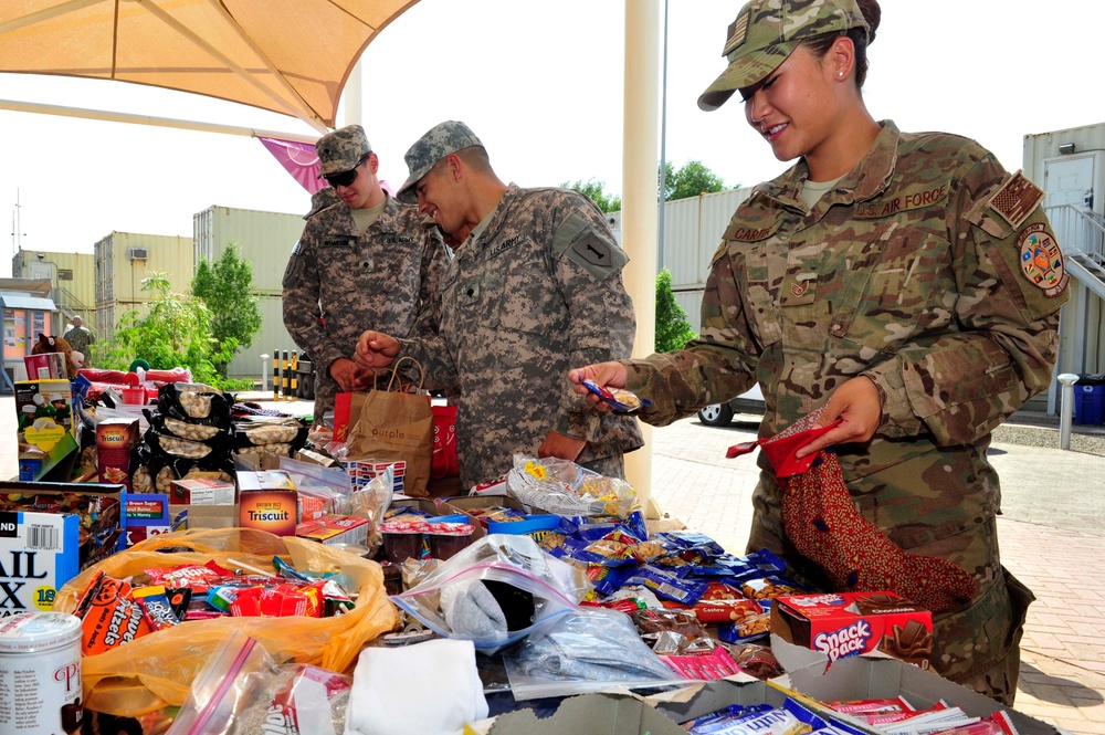 Camp Lemonnier religious programs specialists hand out Christmas gifts