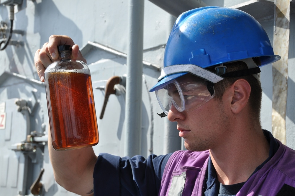 USS Anzio sailor inspects fuel sample