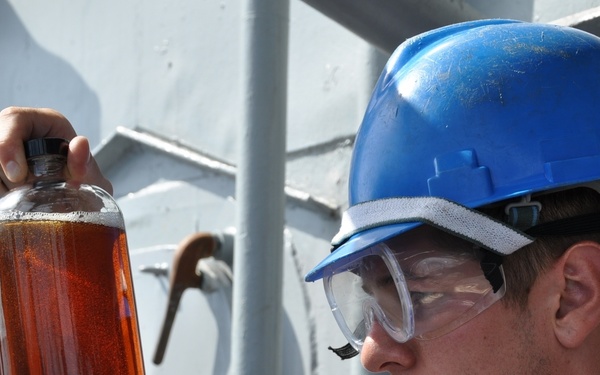 USS Anzio sailor inspects fuel sample