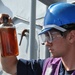 USS Anzio sailor inspects fuel sample