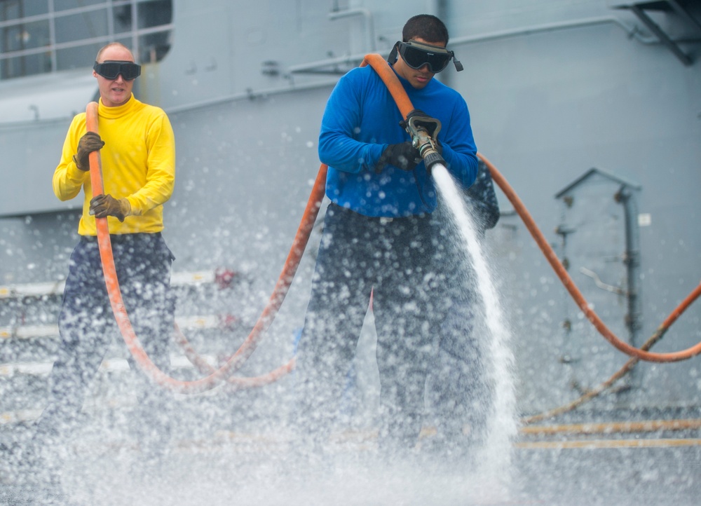 USS Peleliu conducts flight deck wash down