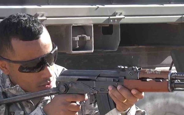 NCO takes aim with an AK-47 during training