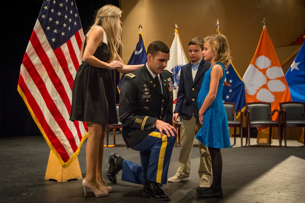 Family pins 2nd lieutenant at ROTC commissioning ceremony