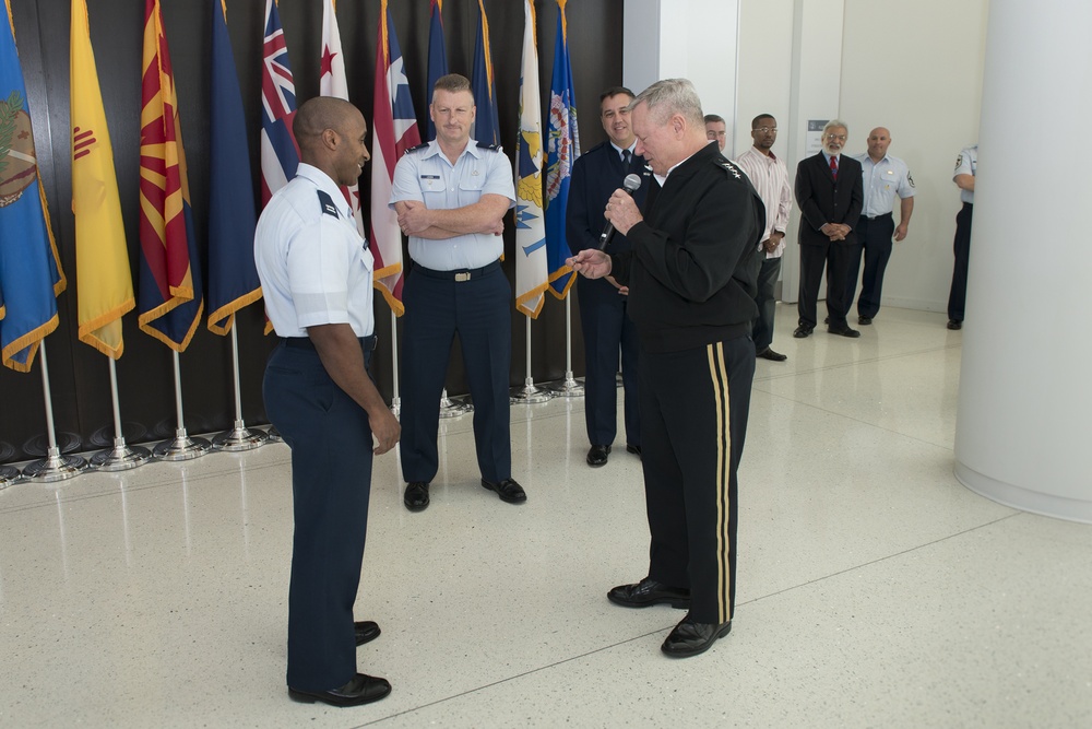CNGB presents his coin to Airman