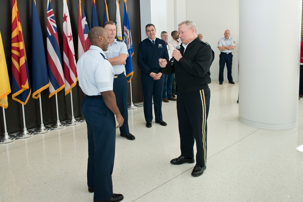 CNGB presents his coin to Airman