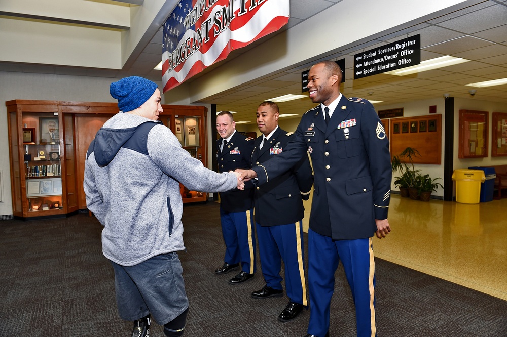 Wounded warrior is greeted by Army Reserve soldiers during honor at high school