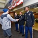 Wounded warrior is greeted by Army Reserve soldiers during honor at high school
