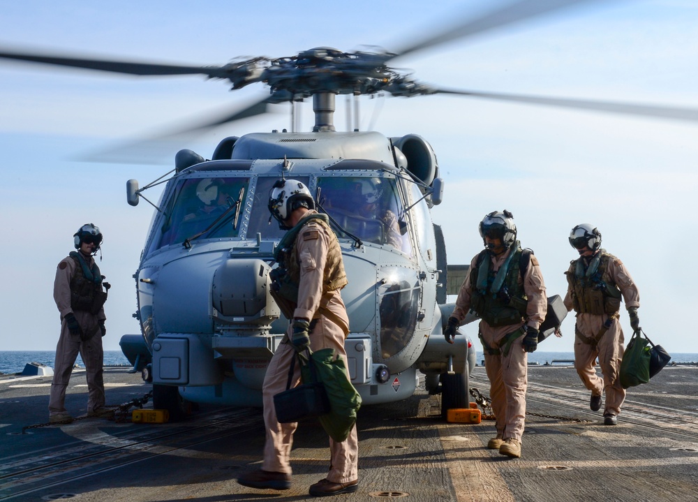 Sailors inspect an MH-60S Seahawk helicopter