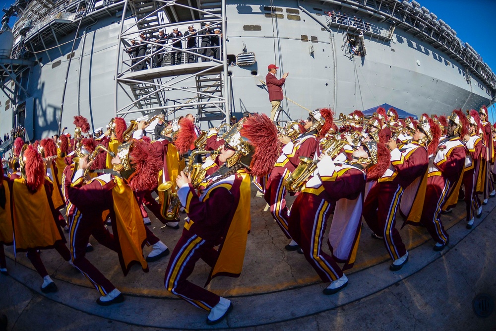 Marching band performs during a Battle of the Bands competition beside the amphibious assault ship USS Essex