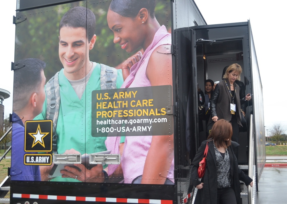 Influential leaders in medical field tour Army traveling truck
