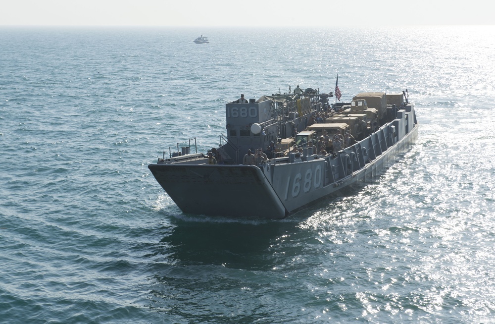 Landing Craft Utility 1680 approaches USS Comstock