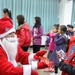 Santas surprise, celebrate Christmas with local kids
