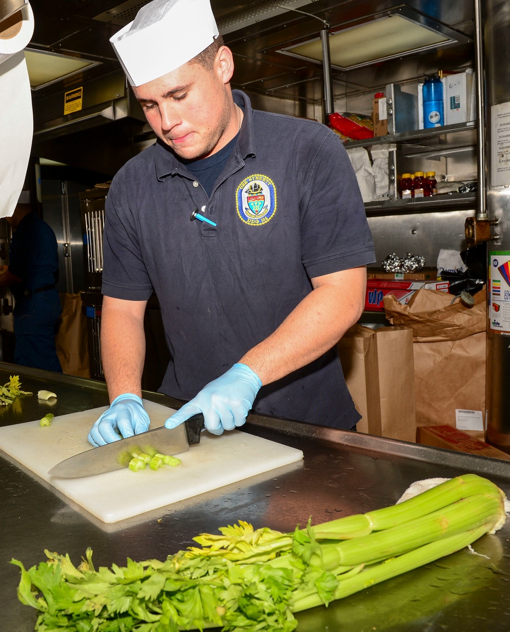 USS Sterett Sailors prepare dinner