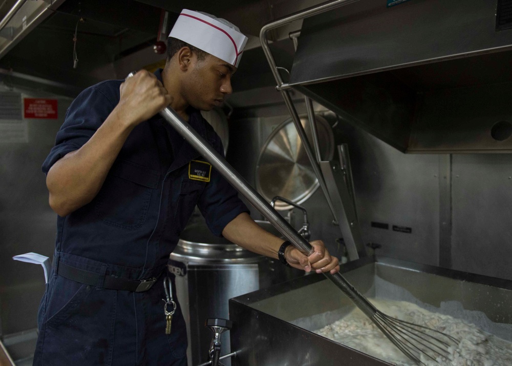 USS Dewey Sailor prepares dinner