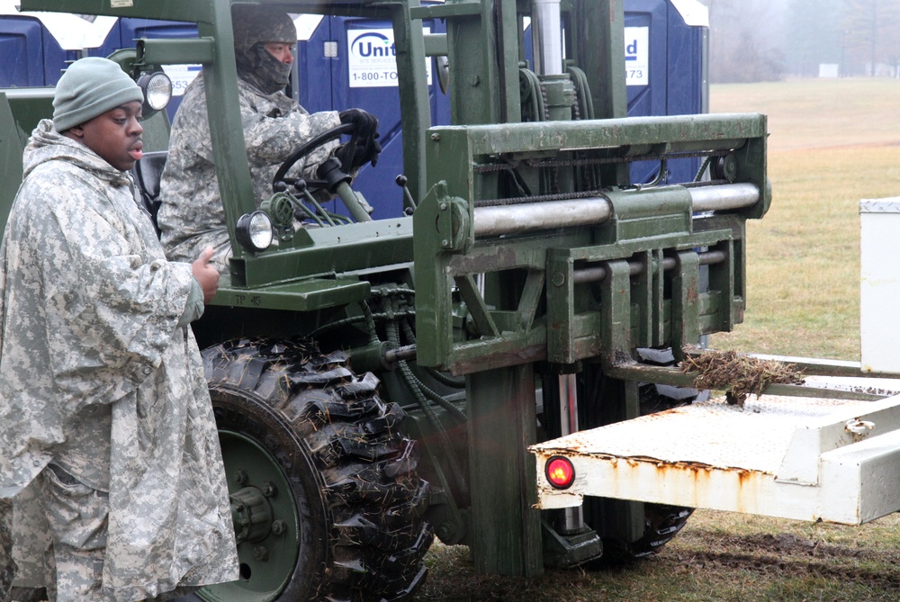 Soldiers from the 75th Combat Support Hospital assist stuck vehicle