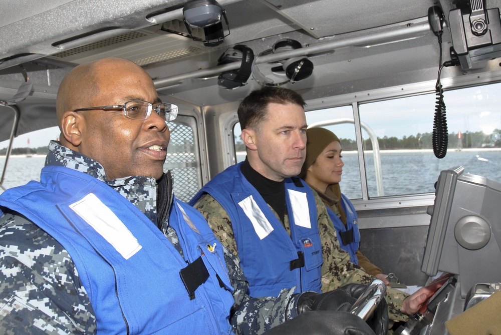 Navy Reserve Forces Command commander mans the helm of assault craft unit