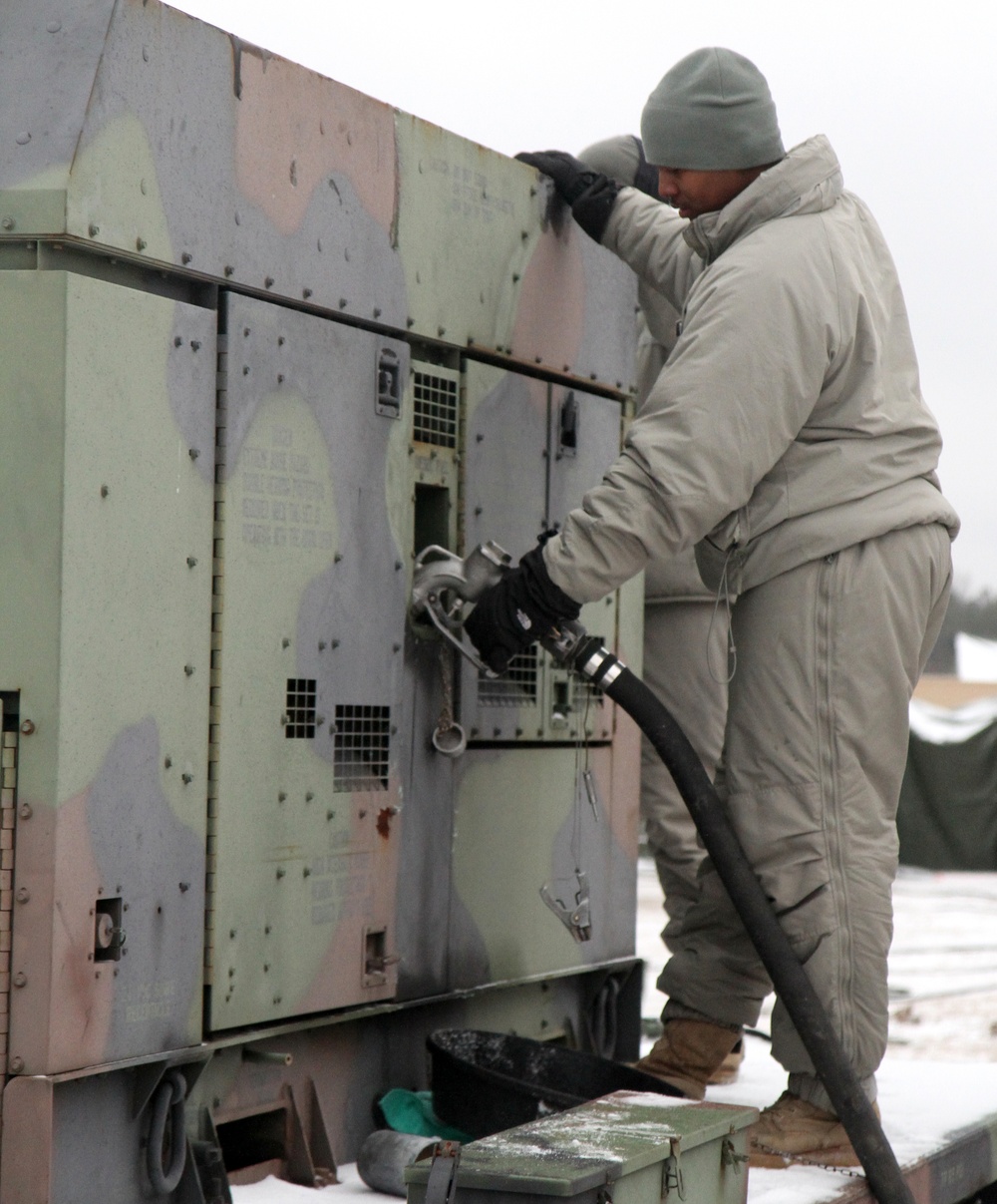 Soldier refuels a generator during WAREX 2015