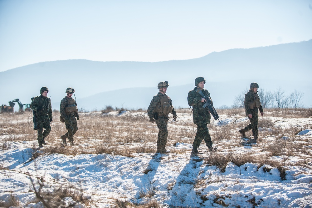 United States Marines and Bulgarian soldiers walk together