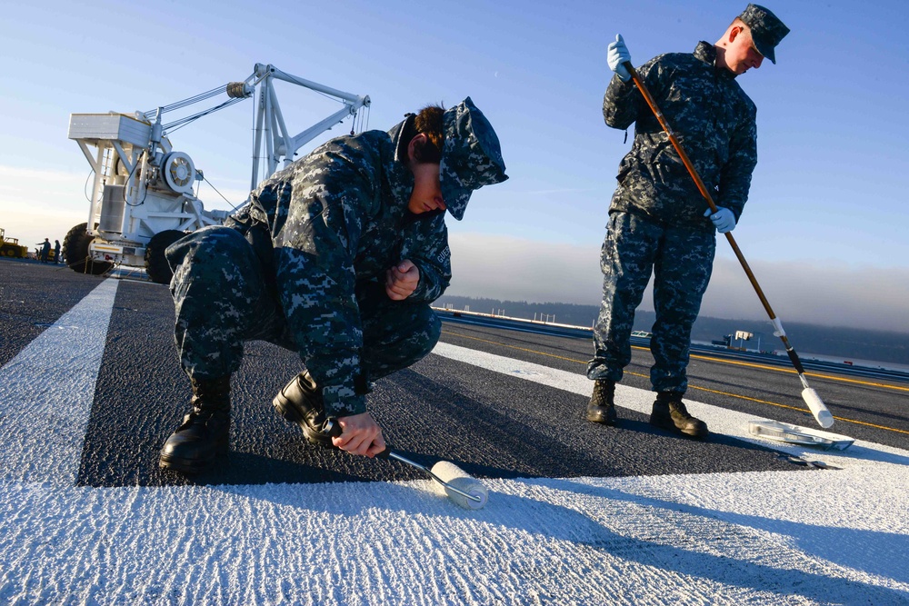 USS John C. Stennis Sailors paint ladder lines