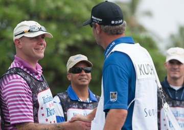 US military service members caddie for pro golfers during Sony Open in Hawaii Pro-Am Tournament