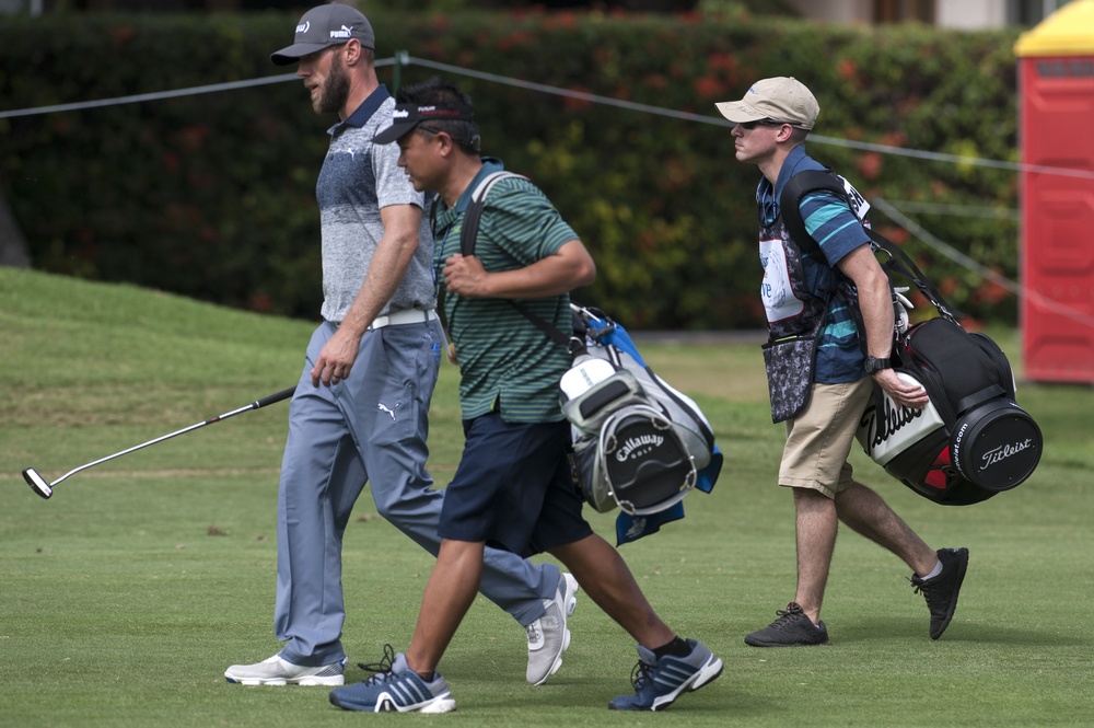 US military service members caddie for pro golfers during Sony Open in Hawaii Pro-Am Tournament