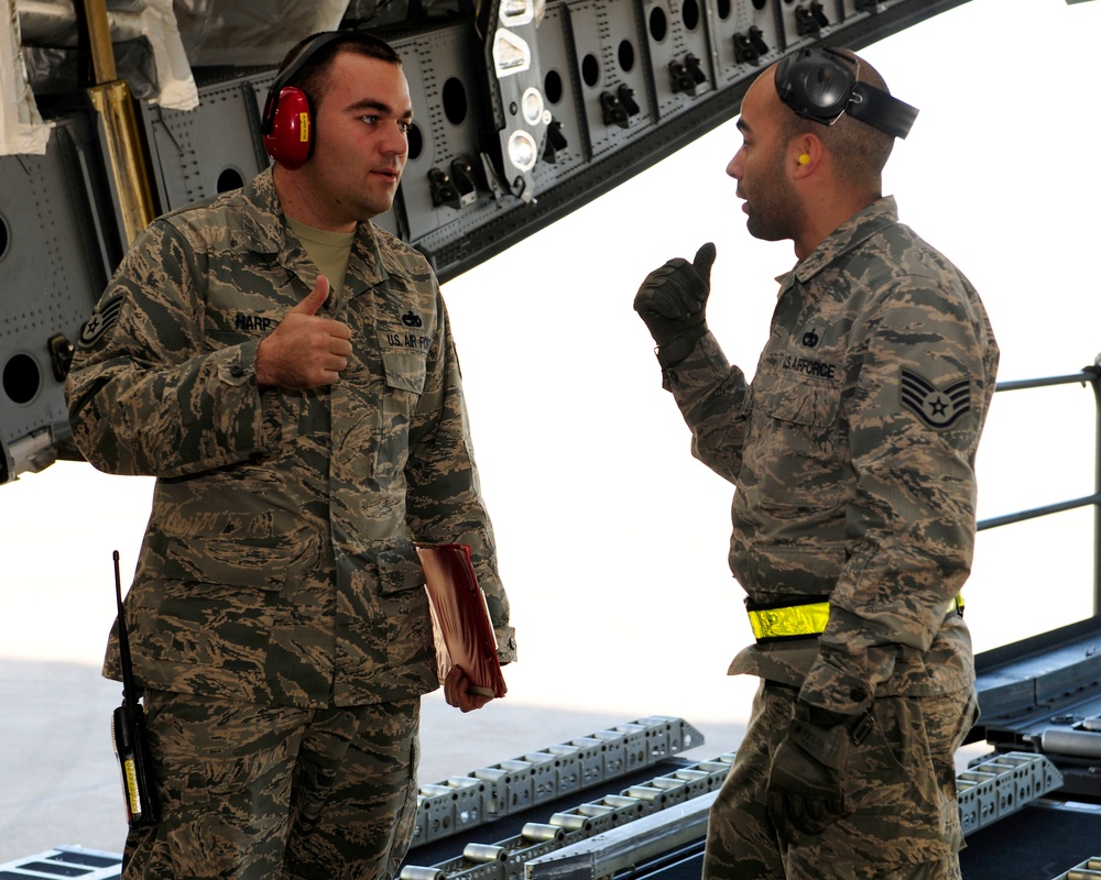 728th Air Mobility Squadron members process cargo from a C-17 Globemaster III